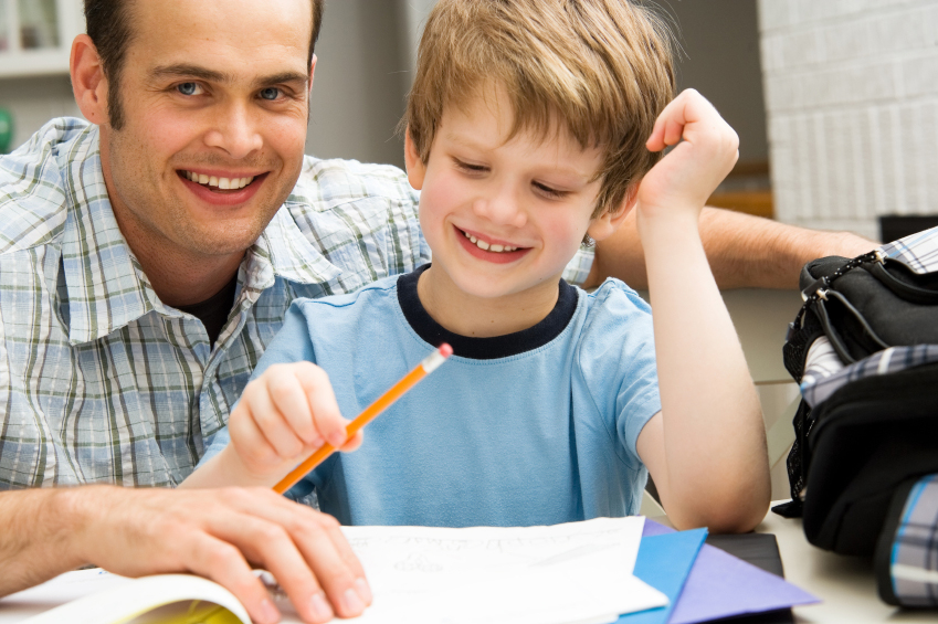 Parent and happy child doing homework.